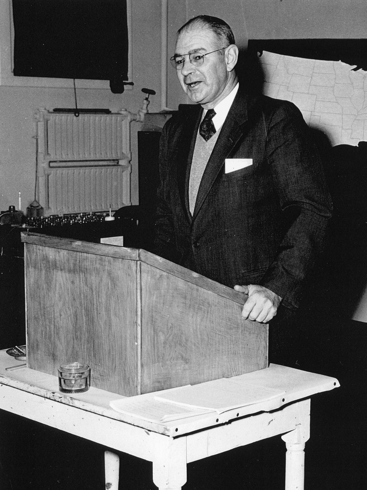 Dr. Ralph E. Hodgson behind lecturn