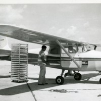 Loading dispersing plan with fly holding cartons, approximately 1,000 per plane