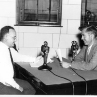 Henry A. Wallace, Secretary of Agriculture (right) and Morse Salisbury, USDA broadcaster, doing a program for the National Farm and Home Hour, circa 1939.