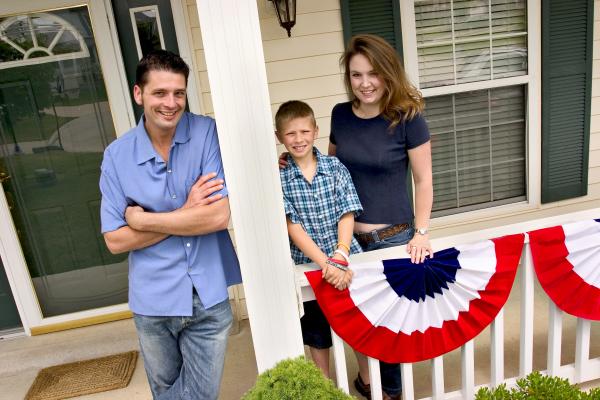 Family standing on a porch.